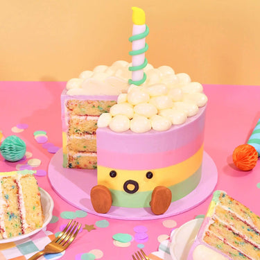 Jellycat Rainbow Birthday Cake with four layered sponge, pastel ombre buttercream, and candle decoration by Crumbs & Doilies.